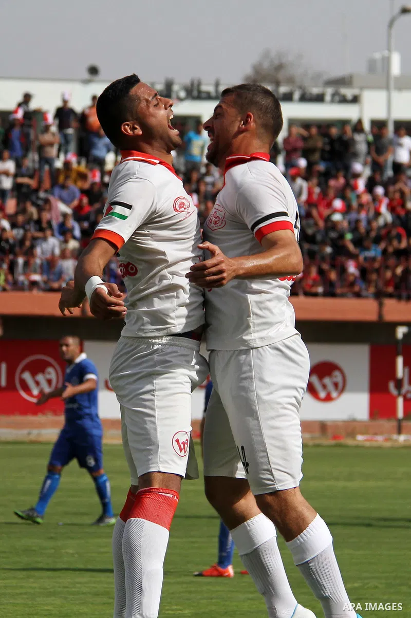 Palestinian players of Shabab Khan Younis football club celebrate after scoring a goal during the final football match of the Palestine Cup for the southern governorates with Shabab Rafah football club at Palestine stadi...
