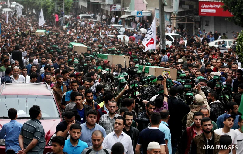 Palestinians mourners carry bodies of six members of Ezzedine al-Qassam Brigades, the armed wing of the Palestinian Hamas movement who were killed in an unexplained explosion the night before, during their funeral in Dei...