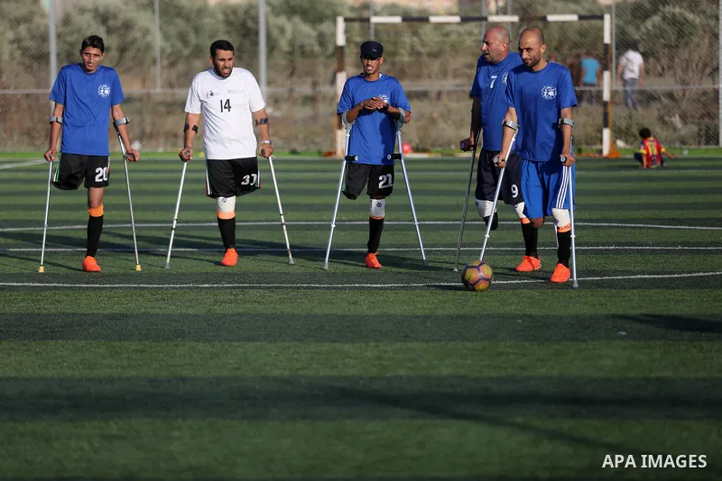 Disabled Palestinians who were lost their limbs during the Israeli wars on Gaza Strip participate in football training, in Deir al-Balah in the center of Gaza Strip on May 7, 2018. Photo by Ashraf Amra