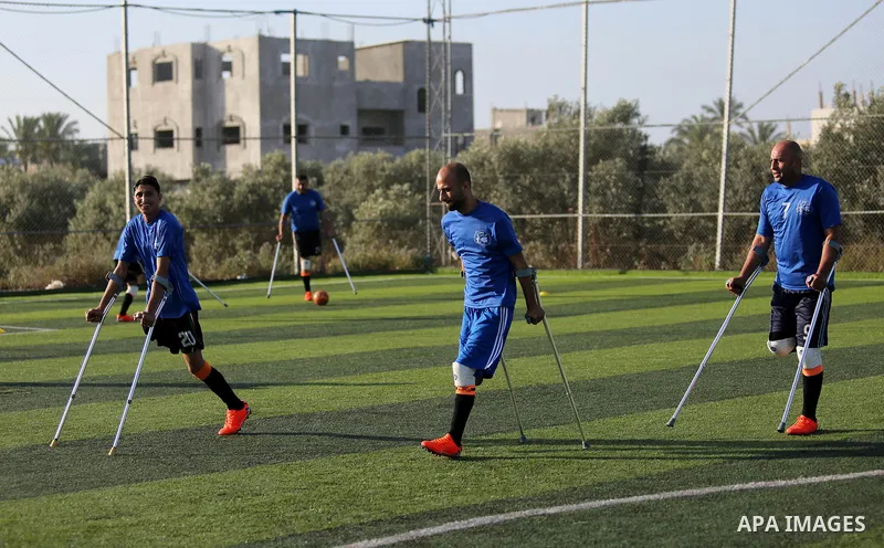 Disabled Palestinians who were lost their limbs during the Israeli wars on Gaza Strip participate in football training, in Deir al-Balah in the center of Gaza Strip on May 7, 2018. Photo by Ashraf Amra