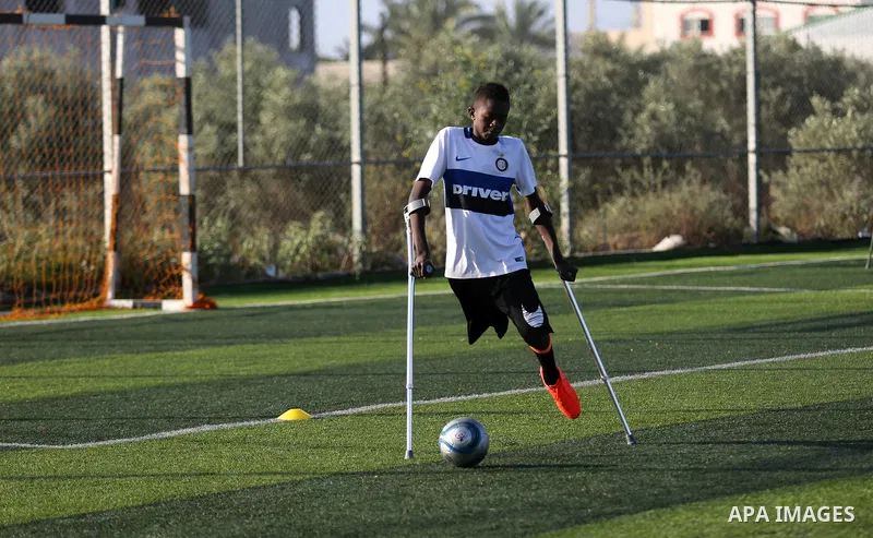 Disabled Palestinians who were lost their limbs during the Israeli wars on Gaza Strip participate in football training, in Deir al-Balah in the center of Gaza Strip on May 7, 2018. Photo by Ashraf Amra