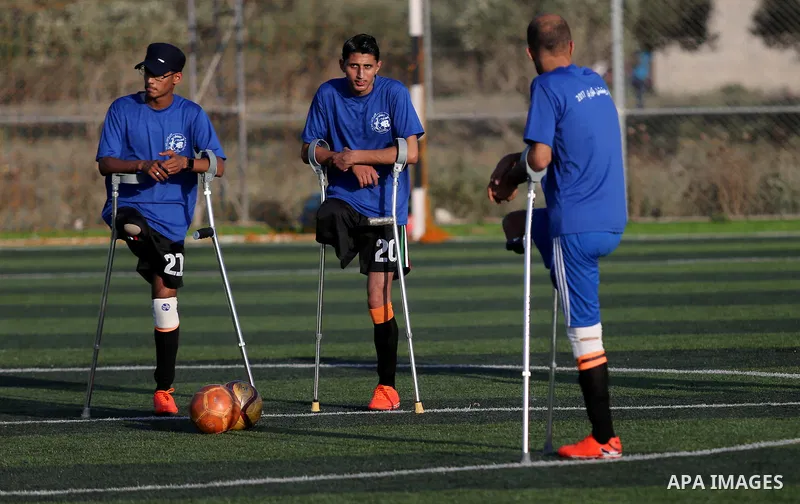 Disabled Palestinians who were lost their limbs during the Israeli wars on Gaza Strip participate in football training, in Deir al-Balah in the center of Gaza Strip on May 7, 2018. Photo by Ashraf Amra