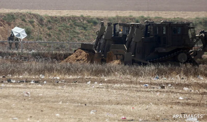 Israeli bulldozers work at the Israel-Gaza border, in Khan Younis in the southern Gaza Strip, May 9, 2018. Photo by Ashraf Amra
