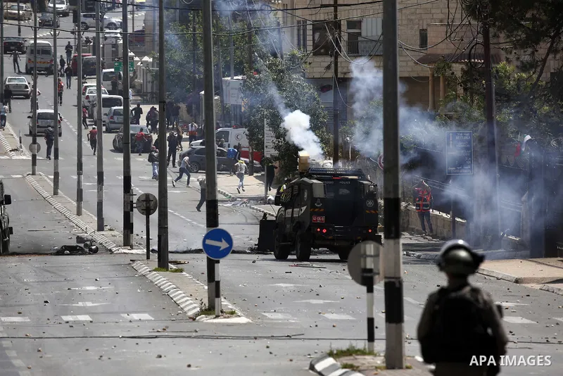 Israeli security forces take position during clashes with Palestinian protesters following a protest against U.S. embassy move to Jerusalem and on the occasion of the 70th anniversary of the "Nakba" in Bethlehem in the o...