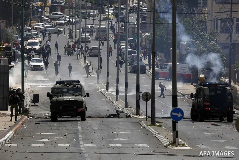 Israeli security forces take position during clashes with Palestinian protesters following a protest against U.S. embassy move to Jerusalem and on the occasion of the 70th anniversary of the "Nakba" in Bethlehem in the o...
