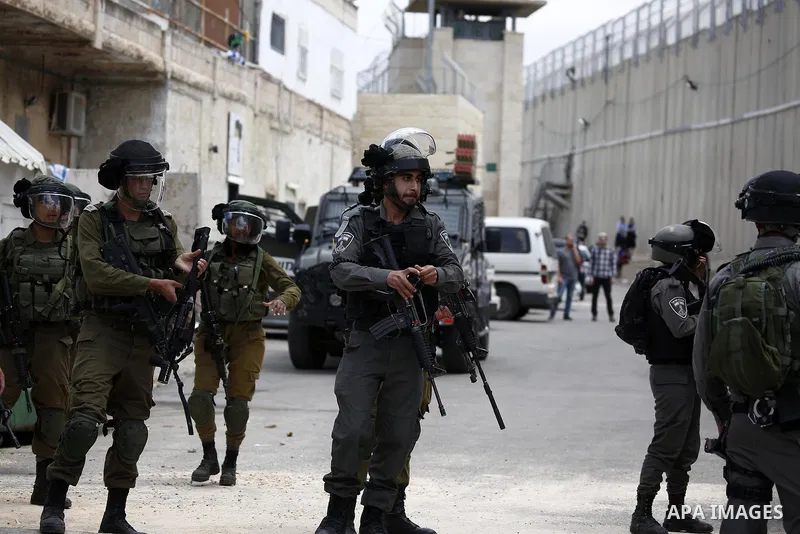 Israeli security forces take position during clashes with Palestinian protesters following a protest against U.S. embassy move to Jerusalem and on the occasion of the 70th anniversary of the "Nakba" in Bethlehem in the o...