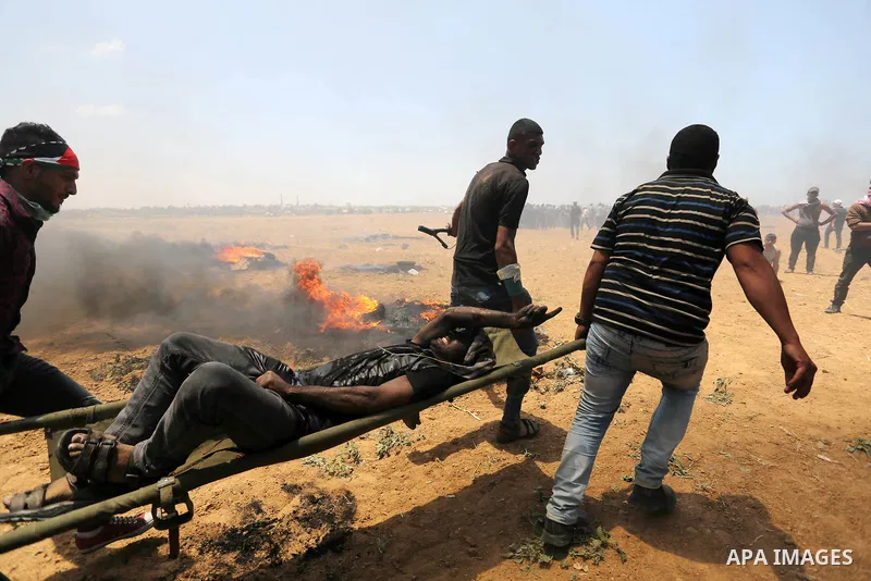A wounded Palestinian protester is evacuated during clashes with Israeli security froces in a tent city protest where Palestinians demand the right to return to their homeland, on the occasion of the 70th anniversary of...