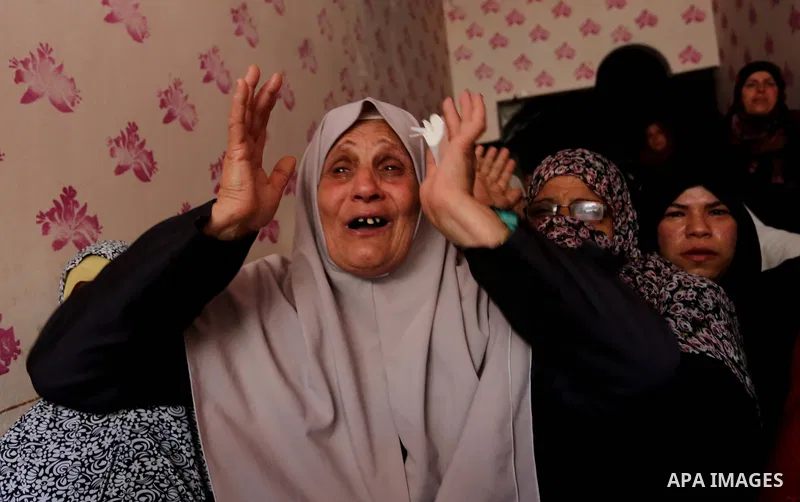 Relatives of Palestinian Mohammed Dwedar, 27, who was killed by Israeli troops during clashes in a tent city protest where Palestinians demand the right to return to their homeland, on the occasion of the 70th anniversar...