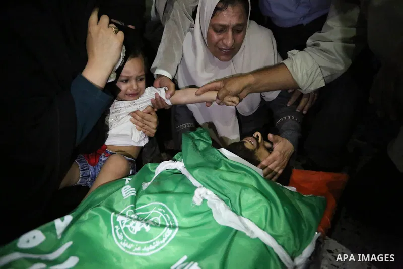 Relatives of Palestinian Mohammed Dwedar, 27, who was killed by Israeli troops during clashes in a tent city protest where Palestinians demand the right to return to their homeland, on the occasion of the 70th anniversar...