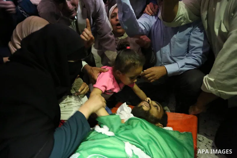 Relatives of Palestinian Mohammed Dwedar, 27, who was killed by Israeli troops during clashes in a tent city protest where Palestinians demand the right to return to their homeland, on the occasion of the 70th anniversar...