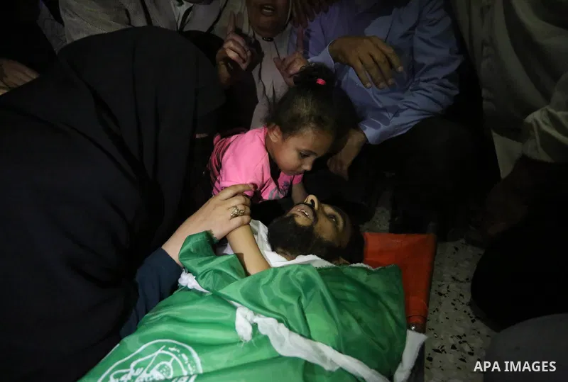 Relatives of Palestinian Mohammed Dwedar, 27, who was killed by Israeli troops during clashes in a tent city protest where Palestinians demand the right to return to their homeland, on the occasion of the 70th anniversar...