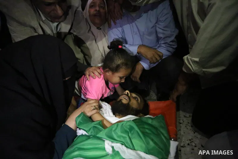 Relatives of Palestinian Mohammed Dwedar, 27, who was killed by Israeli troops during clashes in a tent city protest where Palestinians demand the right to return to their homeland, on the occasion of the 70th anniversar...