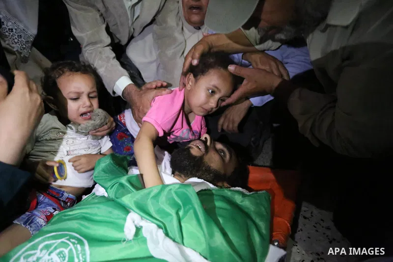 Relatives of Palestinian Mohammed Dwedar, 27, who was killed by Israeli troops during clashes in a tent city protest where Palestinians demand the right to return to their homeland, on the occasion of the 70th anniversar...