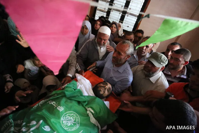 Relatives of Palestinian Mohammed Dwedar, 27, who was killed by Israeli troops during clashes in a tent city protest where Palestinians demand the right to return to their homeland, on the occasion of the 70th anniversar...