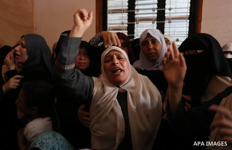 Relatives of Palestinian Mohammed Dwedar, 27, who was killed by Israeli troops during clashes in a tent city protest where Palestinians demand the right to return to their homeland, on the occasion of the 70th anniversar...