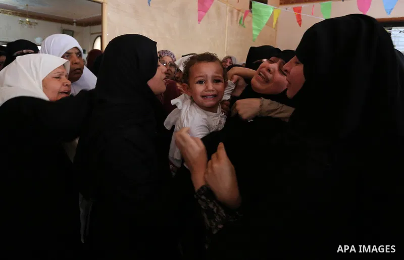 Relatives of Palestinian Mohammed Dwedar, 27, who was killed by Israeli troops during clashes in a tent city protest where Palestinians demand the right to return to their homeland, on the occasion of the 70th anniversar...
