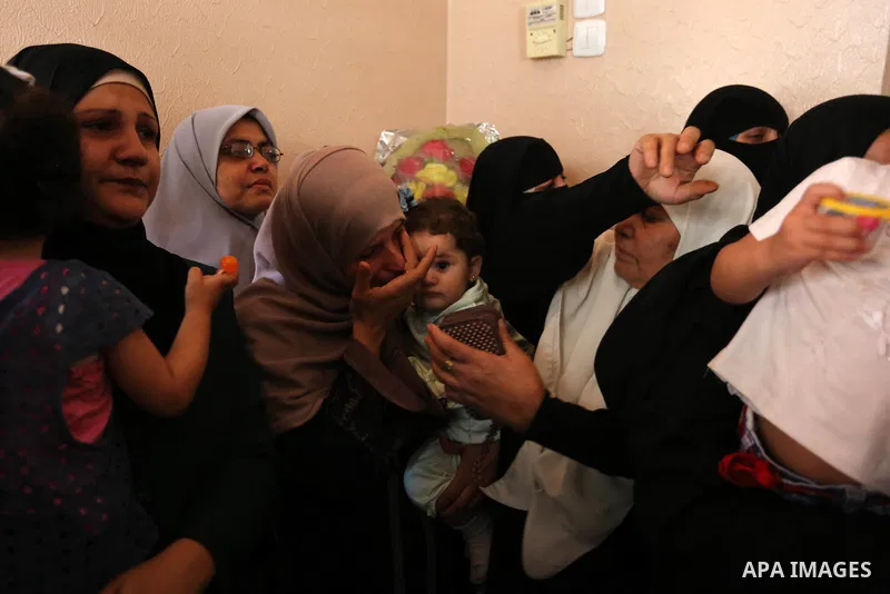 Relatives of Palestinian Mohammed Dwedar, 27, who was killed by Israeli troops during clashes in a tent city protest where Palestinians demand the right to return to their homeland, on the occasion of the 70th anniversar...