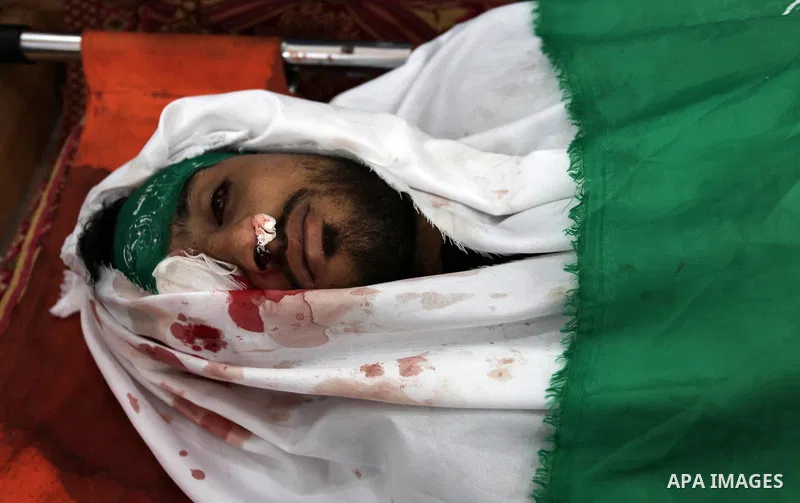Mourners around over the body of Palestinian Yazan al-Tubasi, who was killed by Israeli troops during clashes in a tent city protest where Palestinians demand the right to return to their homeland, on the occasion of the...