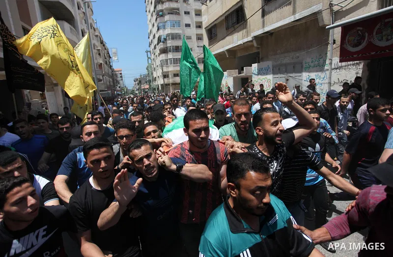 Mourners carry the body of Palestinian Yazan al-Tubasi, who was killed by Israeli troops during clashes in a tent city protest where Palestinians demand the right to return to their homeland, on the occasion of the 70th...