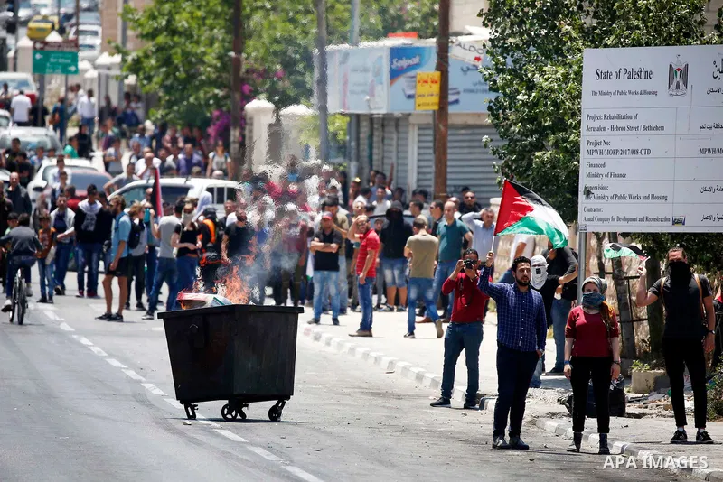 Palestinian protesters gather during clashes with Israeli security forces following a protest against U.S. embassy move to Jerusalem and on the occasion of the 70th anniversary of the "Nakba" or "catastrophe", in the Wes...