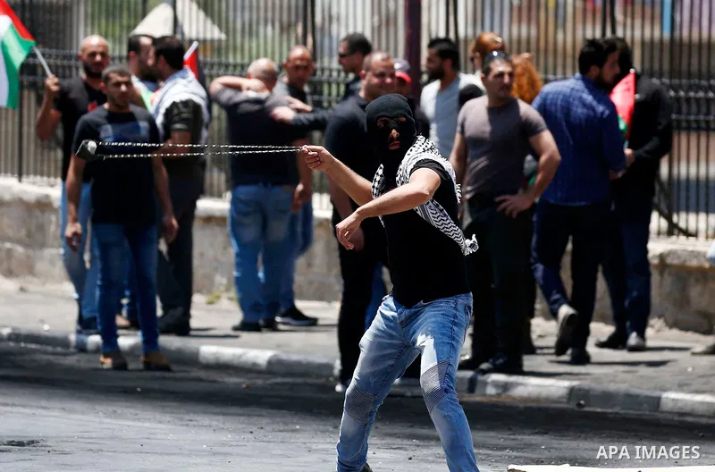 Palestinian protesters gather during clashes with Israeli security forces following a protest against U.S. embassy move to Jerusalem and on the occasion of the 70th anniversary of the "Nakba" or "catastrophe", in the Wes...