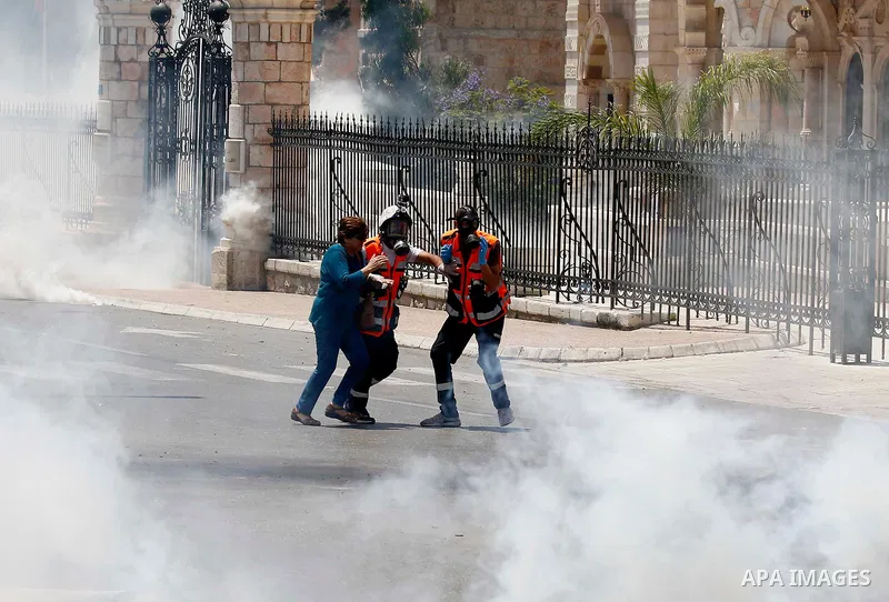 Palestinian protesters gather during clashes with Israeli security forces following a protest against U.S. embassy move to Jerusalem and on the occasion of the 70th anniversary of the "Nakba" or "catastrophe", in the Wes...