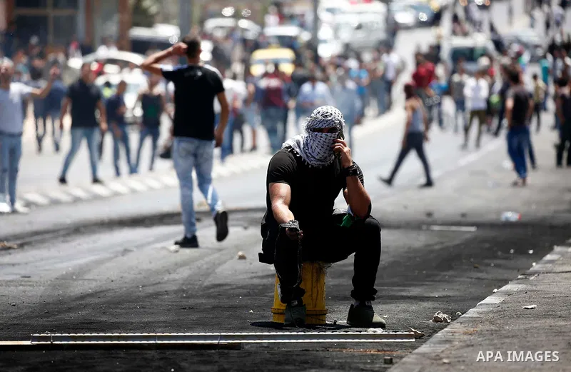 Palestinian protesters gather during clashes with Israeli security forces following a protest against U.S. embassy move to Jerusalem and on the occasion of the 70th anniversary of the "Nakba" or "catastrophe", in the Wes...