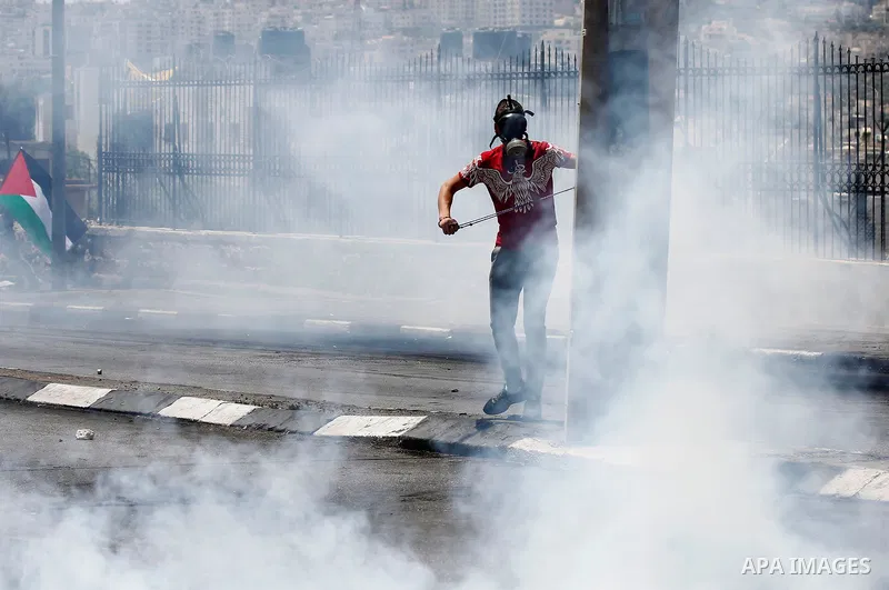 Palestinian protesters gather during clashes with Israeli security forces following a protest against U.S. embassy move to Jerusalem and on the occasion of the 70th anniversary of the "Nakba" or "catastrophe", in the Wes...