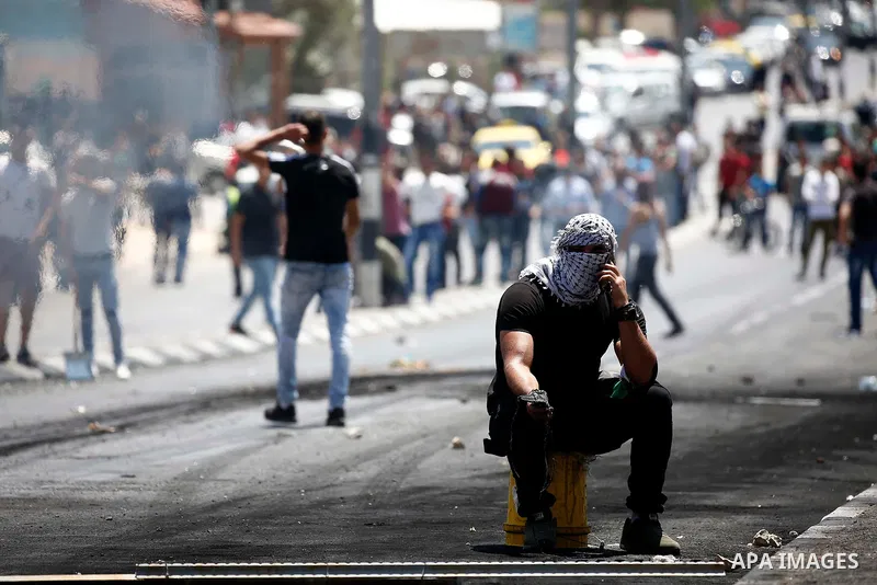 Palestinian protesters gather during clashes with Israeli security forces following a protest against U.S. embassy move to Jerusalem and on the occasion of the 70th anniversary of the "Nakba" or "catastrophe", in the Wes...