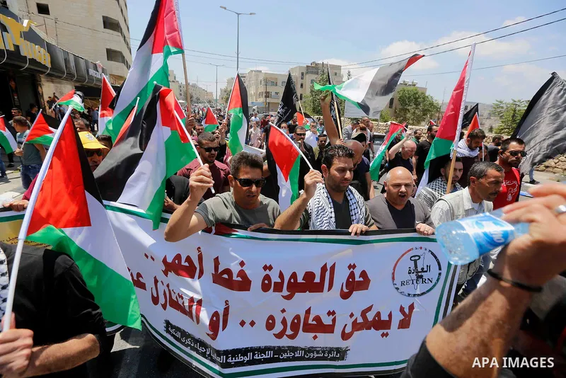 Palestinian protesters gather during clashes with Israeli security forces following a protest against U.S. embassy move to Jerusalem and on the occasion of the 70th anniversary of the "Nakba" or "catastrophe", in the Wes...