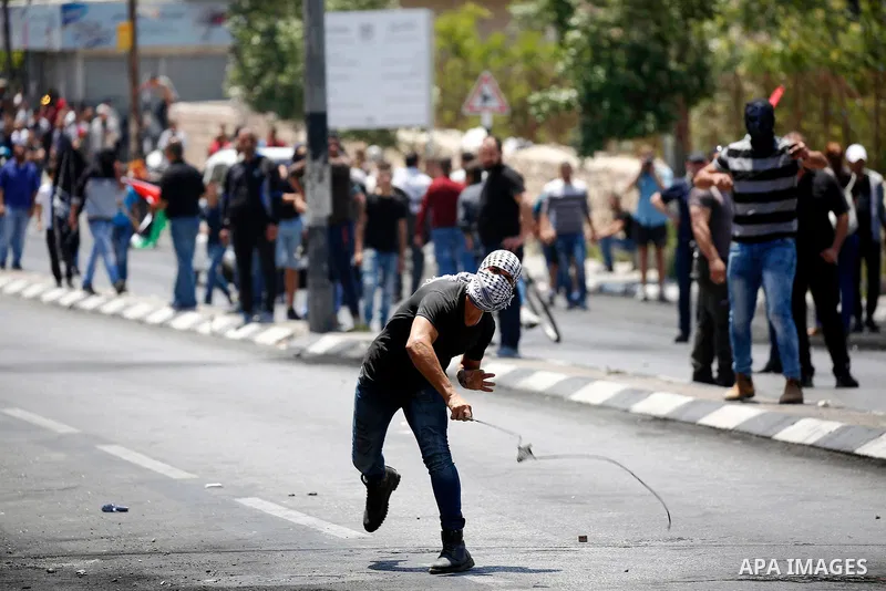 Palestinian protesters gather during clashes with Israeli security forces following a protest against U.S. embassy move to Jerusalem and on the occasion of the 70th anniversary of the "Nakba" or "catastrophe", in the Wes...