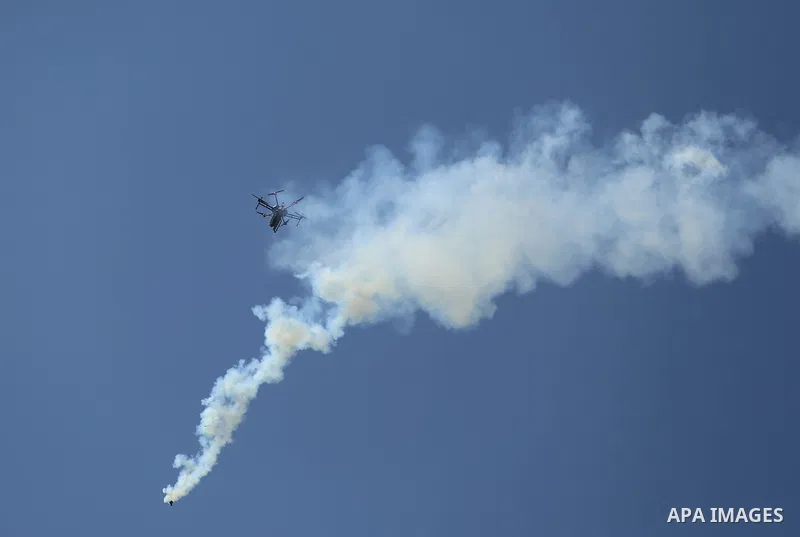 A picture taken on May 15, 2018 shows an Israeli quadcopter drone flying over Palestinian protesters and throw tear gas canisters during clashes in a tent city protest where Palestinians demand the right to return to the...