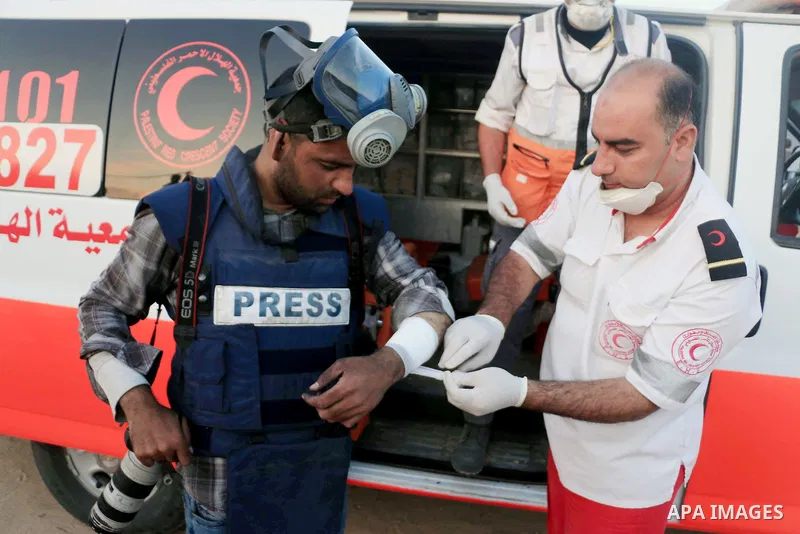 A Palestinian photographer, Ashraf Amra, receives treatment as he covering a demonstration where Palestinians demand the right to return to their homeland, on the occasion of the 70th anniversary of the "Nakba", and agai...