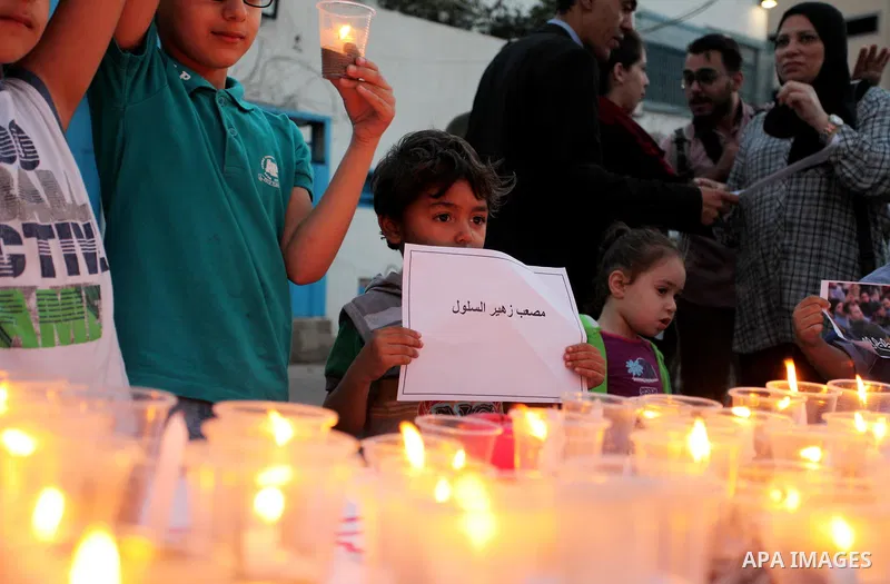 Palestinians light candles during a protest two days after at least 60 Palestinians were killed and 2,400 were injured including children, were shot and killed by Israeli soldiers as they gathered to demonstrate along th...