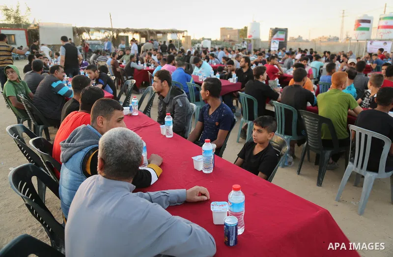 Palestinian muslims prepare to break their fast on the holy fasting month of Ramadan, at the Israel-Gaza border, in east of Gaza city, on May 17, 2018. Ramadan is sacred to Muslims because it is during that month that tr...