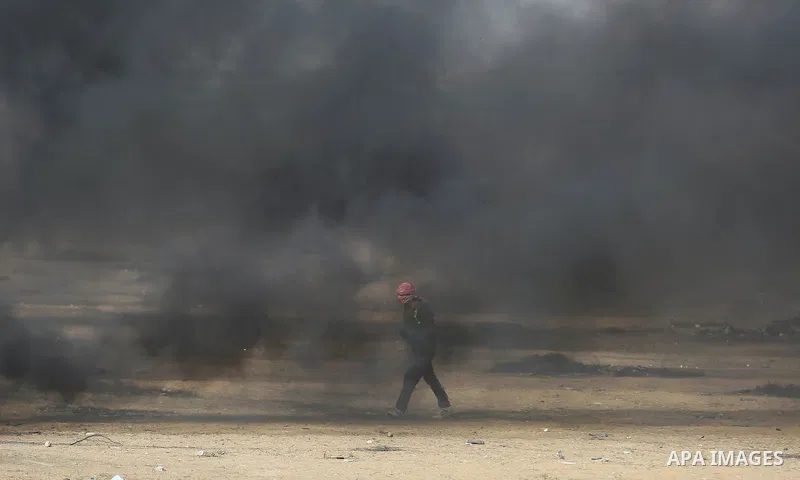 Palestinian protesters gather during clashes with Israeli security froces in a tent city protest where Palestinians demand the right to return to their homeland and against U.S. embassy move to Jerusalem at the Israel-Ga...