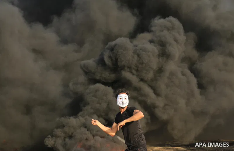 Palestinian protesters gather during clashes with Israeli security froces in a tent city protest where Palestinians demand the right to return to their homeland and against U.S. embassy move to Jerusalem at the Israel-Ga...