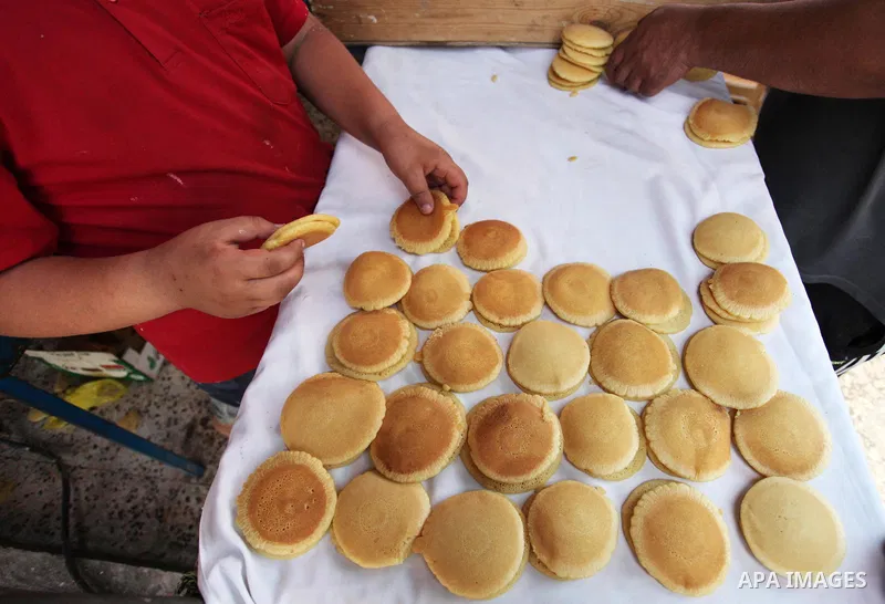 A Palestinian vendor prepares "Qatayef", traditional pancakes that are popular during the Muslim fasting month of Ramadan, at a market in Gaza city on May 19, 2018. Ramadan is sacred to Muslims because it is during that...