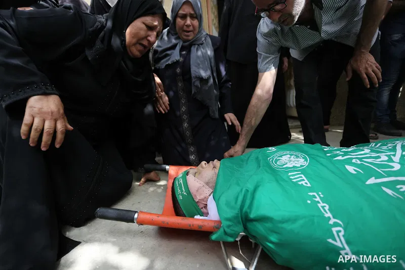 Mourners carry the body of Palestinian Mohammed Alian, 20, who died of wounds he sustained during clashes with Israeli troops in a tent city protest where Palestinians demand the right to return to their homeland and aga...