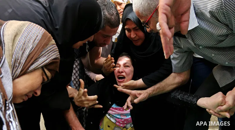 Relatives of Palestinian Mohammed Alian, 20, who died of wounds he sustained during clashes with Israeli troops in a tent city protest where Palestinians demand the right to return to their homeland and against U.S. emba...