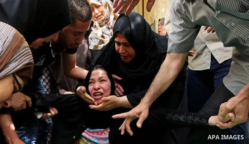 Relatives of Palestinian Mohammed Alian, 20, who died of wounds he sustained during clashes with Israeli troops in a tent city protest where Palestinians demand the right to return to their homeland and against U.S. emba...