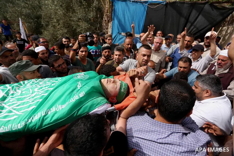 Mourners carry the body of Palestinian Mohammed Alian, 20, who died of wounds he sustained during clashes with Israeli troops in a tent city protest where Palestinians demand the right to return to their homeland and aga...