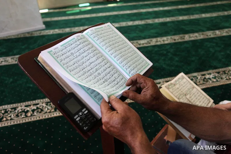 A Palestinian man reads the Koran, Islam's holiest book, at a mosque in Gaza City on the Muslim holy month of Ramadan, on May 20, 2018. Ramadan is sacred to Muslims because it is during that month that tradition says the...