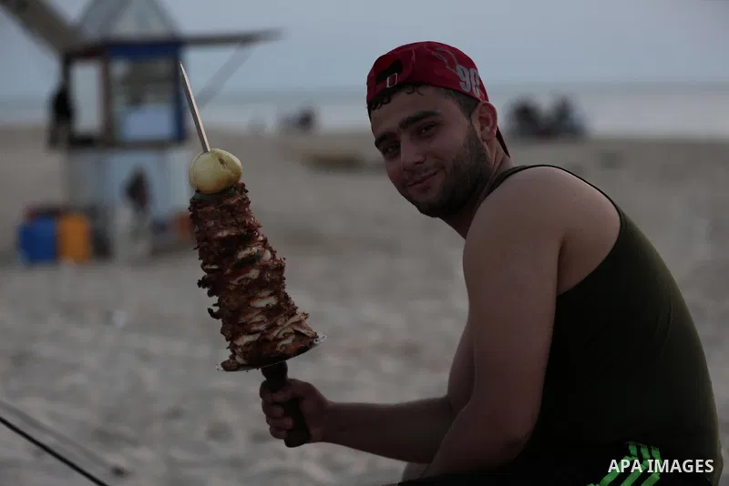 A Palestinian family gathers at the beach to break their fast during the Muslim Holy month of Ramadan, in Gaza City, on May 21, 2018. Ramadan is sacred to Muslims because it is during that month that tradition says the K...