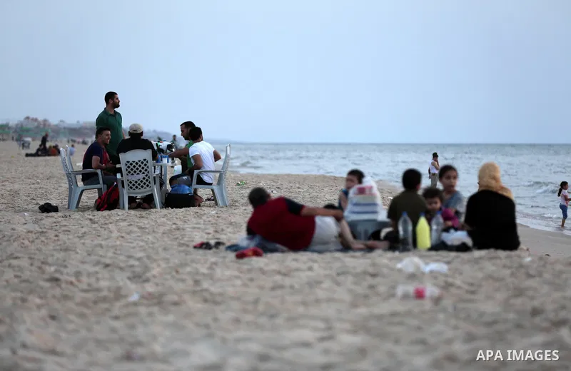 A Palestinian family gathers at the beach to break their fast during the Muslim Holy month of Ramadan, in Gaza City, on May 21, 2018. Ramadan is sacred to Muslims because it is during that month that tradition says the K...