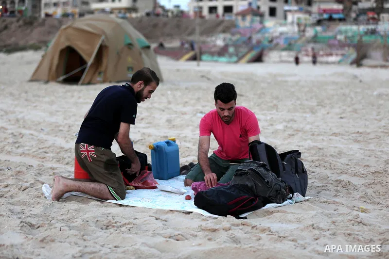 A Palestinian family gathers at the beach to break their fast during the Muslim Holy month of Ramadan, in Gaza City, on May 21, 2018. Ramadan is sacred to Muslims because it is during that month that tradition says the K...