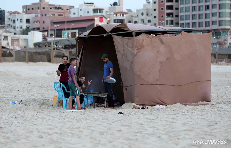 A Palestinian family gathers at the beach to break their fast during the Muslim Holy month of Ramadan, in Gaza City, on May 21, 2018. Ramadan is sacred to Muslims because it is during that month that tradition says the K...