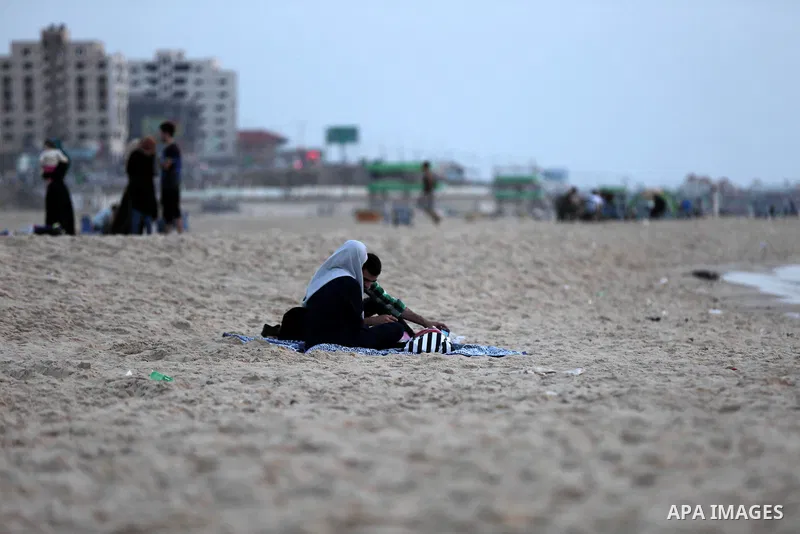 A Palestinian family gathers at the beach to break their fast during the Muslim Holy month of Ramadan, in Gaza City, on May 21, 2018. Ramadan is sacred to Muslims because it is during that month that tradition says the K...