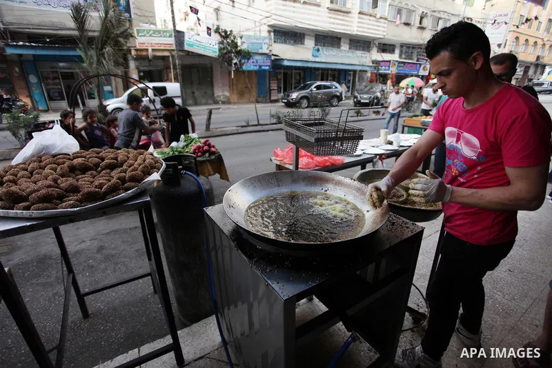 A Palestinian vendor prepares traditional chickpeas known as "Falafel" for breakfasting on the Muslim holy fasting month of Ramadan in Gaza city on May 21, 2018. Ramadan is sacred to Muslims because it is during that mon...