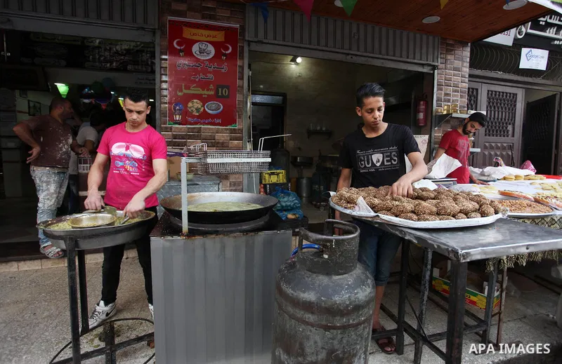 A Palestinian vendor prepares traditional chickpeas known as "Falafel" for breakfasting on the Muslim holy fasting month of Ramadan in Gaza city on May 21, 2018. Ramadan is sacred to Muslims because it is during that mon...